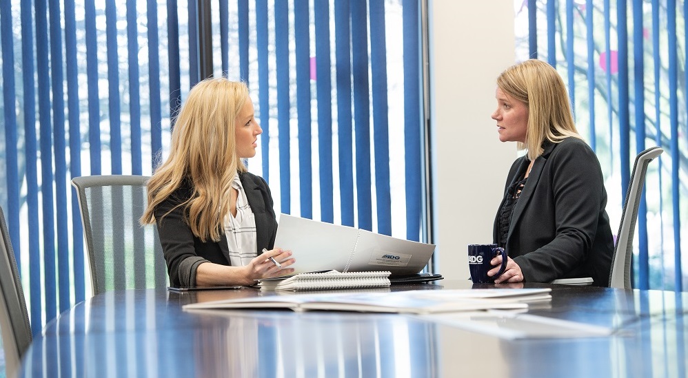 Two women going over accounting work