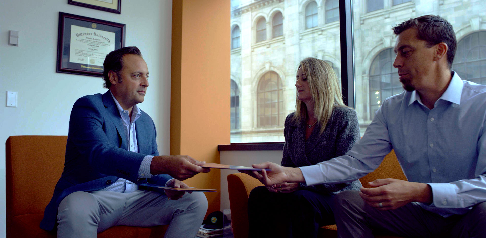 BST employee meeting with two clients on a couch in an office