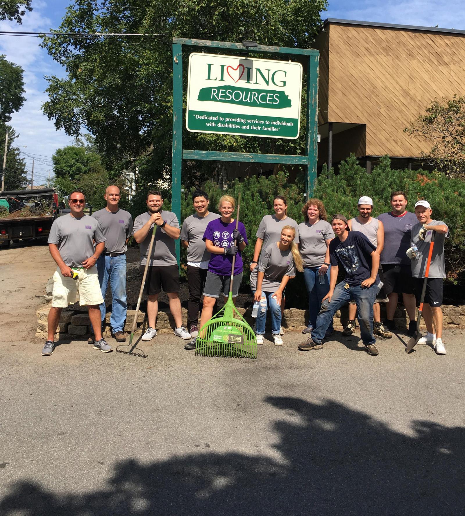BST team members volunteering in the community to do yard cleanup 